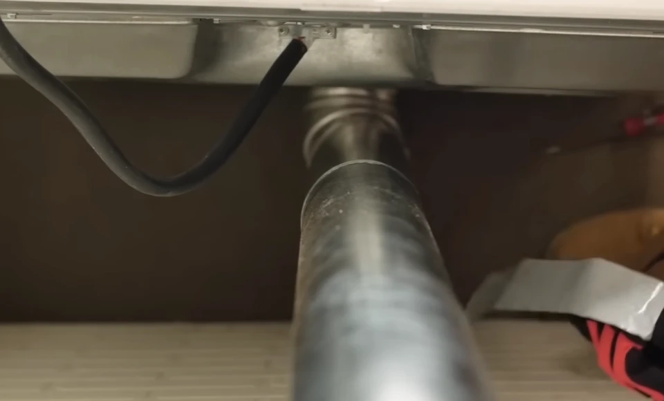 Close-up of dryer vent and exhaust pipe connections and fittings