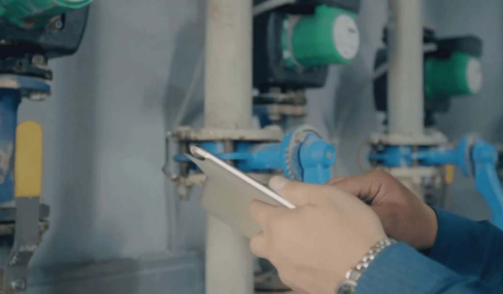 Man checking gas dryer issues on tablet screen for diagnostics