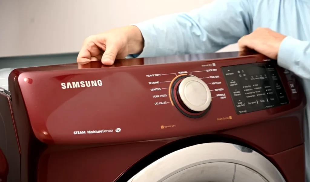 Man holding red Samsung dryer showcasing design and features