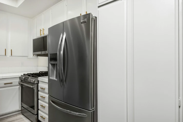 Modern kitchen with stainless steel French door refrigerator and gas stove
