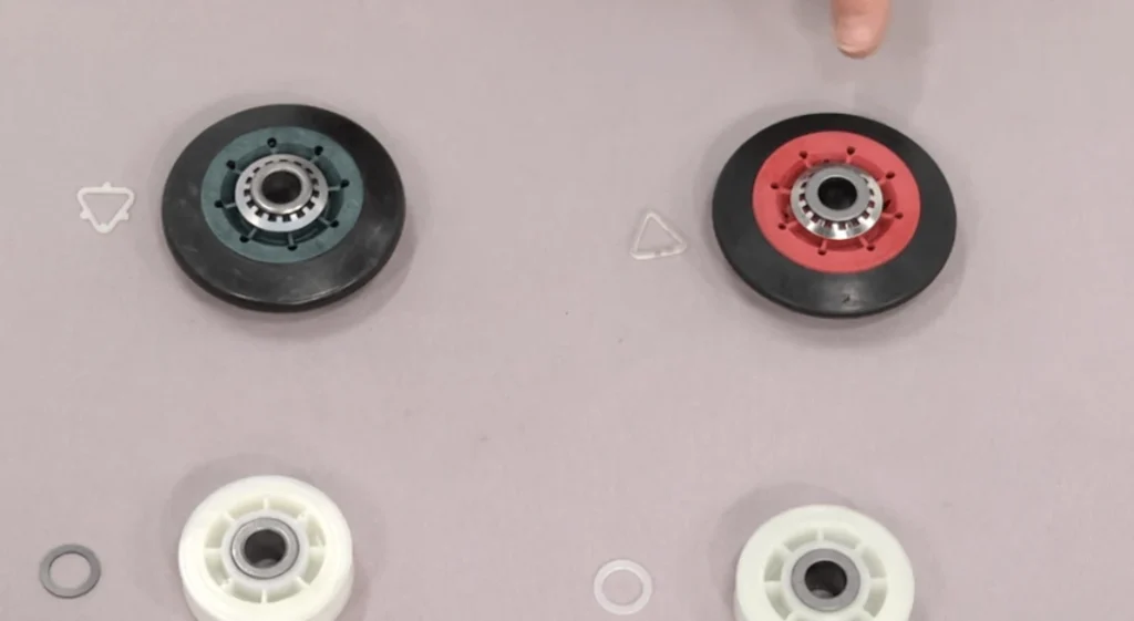 Table showing two types of dryer OEM plastic wheels with different shapes and colors