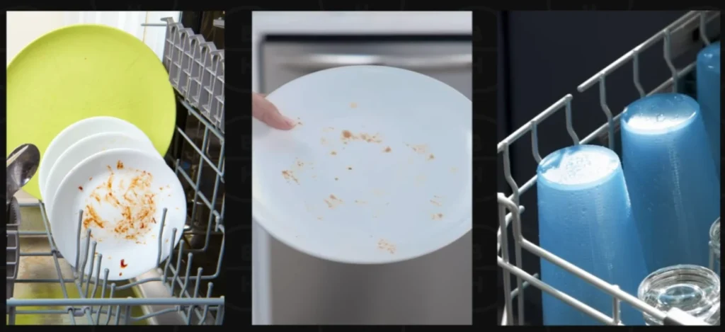 Dirty plates in open dishwasher with hand holding dish and clean cups in drying rack.